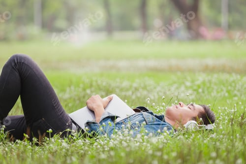 Preview: Asian Young Men Lie About On Nature Listen To Music With Headphone