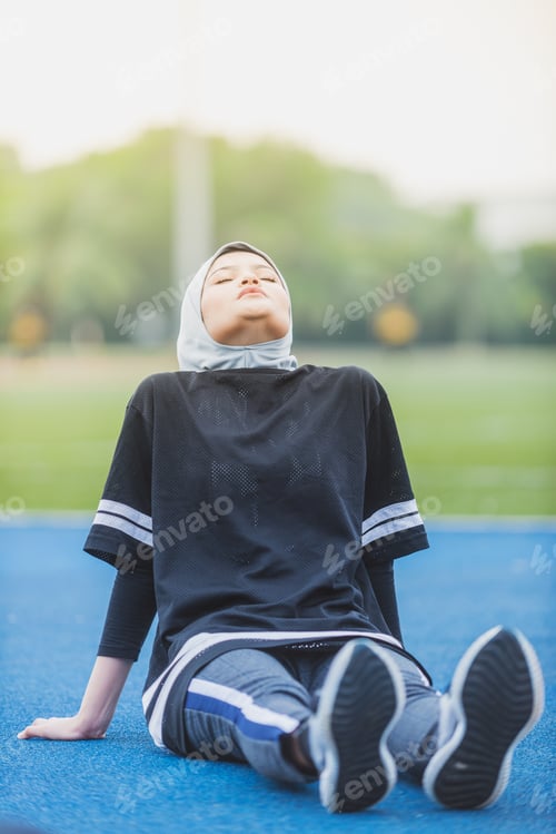 Preview: Muslim Female Stretching At A Stadium Track. Healthy Lifestyle Concept.