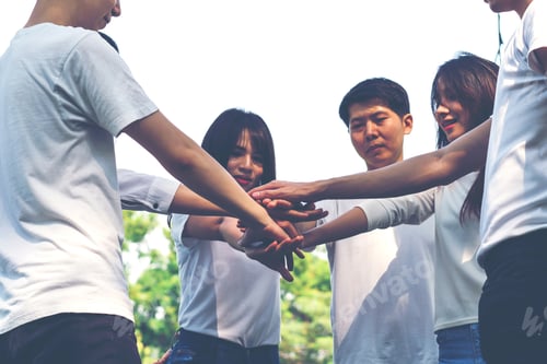 Preview: Young People Putting Hands Together. Friends With Stack Of Hands Showing Unity And Teamwork.