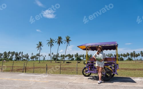 Preview: Portrait Image Of A Young Asian Woman Holding Watermelon Next To The Sidecar While Traveling In