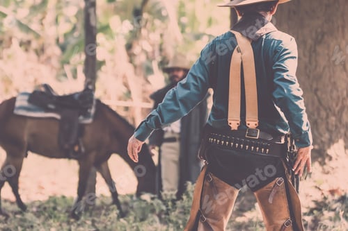 Preview: Back View Of Cowboy With Gun Prepares To Gun Fight.Cowboy With Gun.