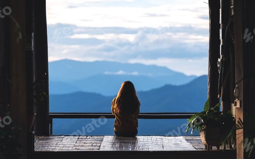 Preview: Rear View Image Of A Female Traveler Sitting And Looking At A Beautiful Mountain And Nature View
