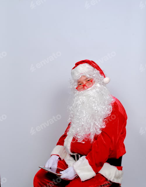 Preview: Portrait Of Good Santa Claus Holding Holding Tablet Gift On A White Background. Christmas And New