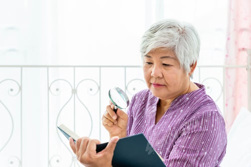 Preview: Happy Elderly Senior Woman Female Lady Enjoy Reading Book Using Magnifying Glass