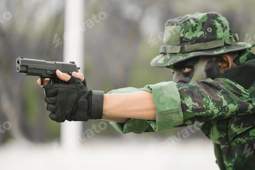 Preview: Soldier Sitting On The Ground And Camouflage In Grass. Soldier Holding Gun Weapon And Wearing Armor