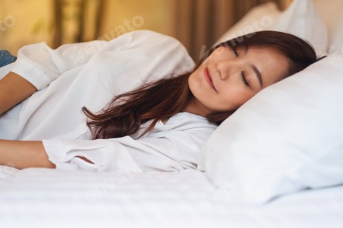 Preview: A Beautiful Asian Woman Sleeping In A White Cozy Bed At Home