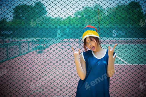 Preview: Portrait Of Hipster Girl Posing By Fence