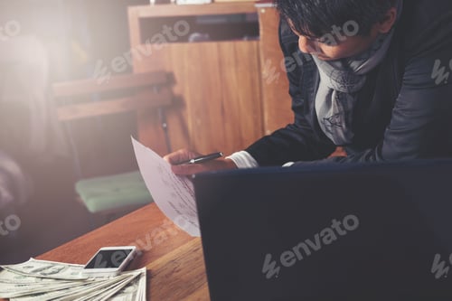 Preview: Casual Business Man Are Working With Notebook Computers , Money , Smart Phones On The Table In