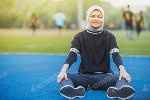 Preview: Muslim Female Stretching At A Stadium Track. Healthy Lifestyle Concept.