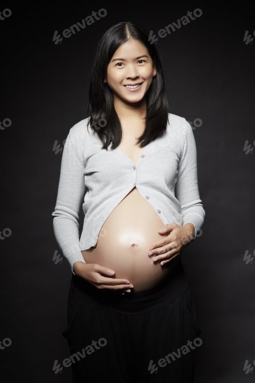 Preview: Pregnant Woman Over Dark Background