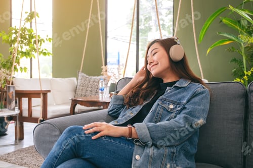 Preview: A Beautiful Asian Woman Enjoy Listening To Music With Headphone With Feeling Happy And Relaxed In