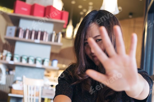 Preview: An Asian Woman Showing Her Hand Sign Cover Her Face To Say No To Someone With Feeling Funny In