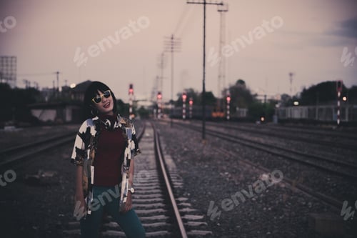 Preview: Portrait Of Asian Hipster Girl On Sunset At Railway Vintage Style,Grain And Noise Has Been Added To