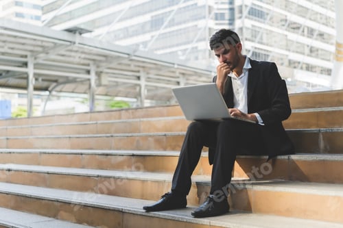 Preview: Handsome Young Manager Working On Laptop While Sitting Outdoors On The Stairs, Concept Of Work Life
