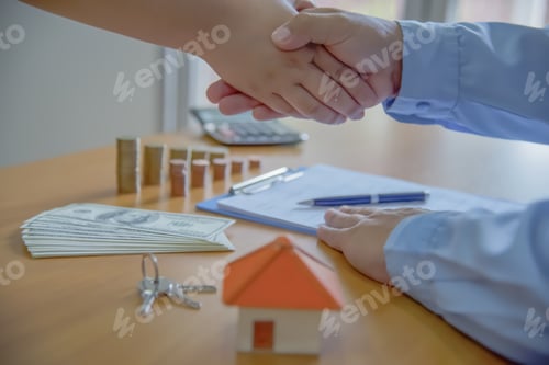 Preview: Estate Agent Shaking Hands With Customer After Contract Signature