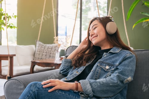Preview: A Beautiful Asian Woman Enjoy Listening To Music With Headphone With Feeling Happy And Relaxed In