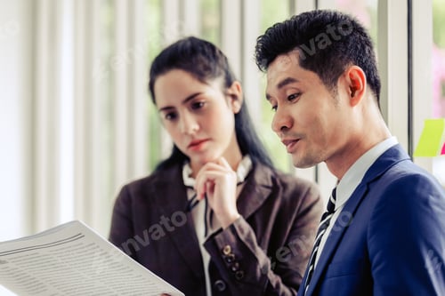 Preview: Asian Businessman Standing Talking Reading Newspaper In Office Smile On Face