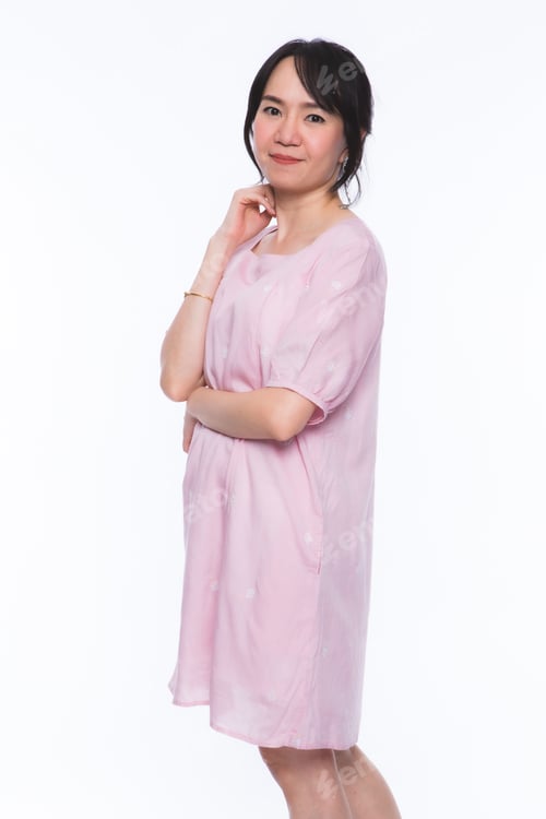 Preview: Portrait Of Happy Asian Woman Fitting Fashionable Dress Over The White Background.