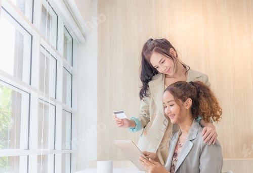 Preview: Happy Shopping Concept, Beautiful Young Female Friends Shopping Online With Tablet Smartphone.