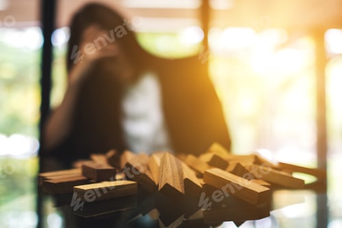 Preview: Businesswoman Get Stressed While Having A Problem At Work In Office With Wooden Blocks Of Tumble