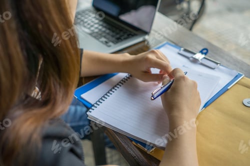 Preview: Young Woman Writing Notes In The Office