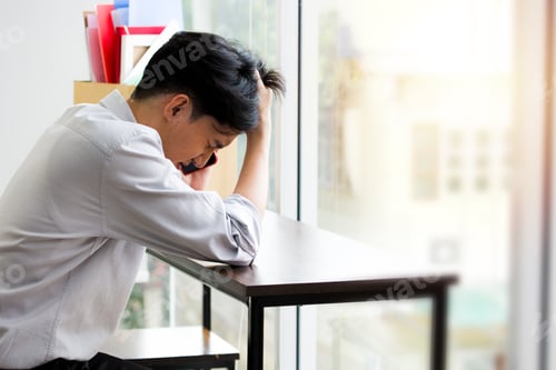 Preview: Asian Man Is Talking On The Phone And Is Stressed Because He Has Been Fired From Work. Dismissed