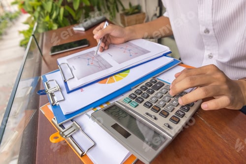 Preview: Young Businessman Calculate Many Financial Reports Outdoor