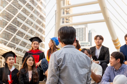 Preview: Group Of Happy Friends Sitting On City Street, Young People Meeting Greeting Outdoor