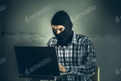 Preview: Computer Hacker Of Terrorist Stealing Information With Laptop In Abandoned Building. Low Key Photo.