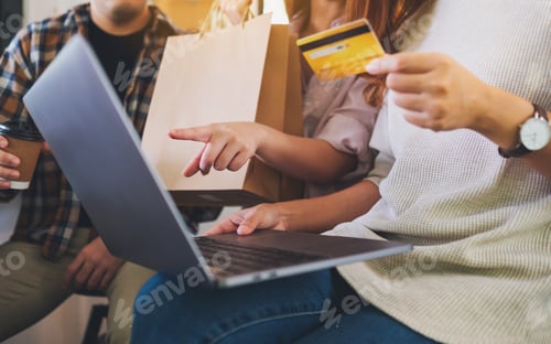 Preview: Group Of Young People Using Laptop And Credit Card For Shopping Online Together