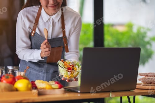 Preview: A Woman Videoblogger Cooking In The Kitchen And Filming, Online Learning Cooking Class Concept