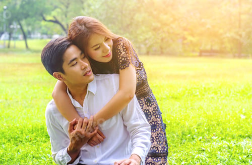 Preview: Happy Loving Couple Hugging In Nature. Portrait Of Young Attractive Smiling Man And Woman Relaxing