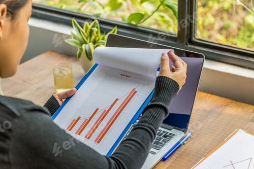 Preview: Close Up Of Asian Woman Holding Sales Graph Report