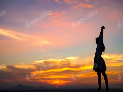 Preview: Silhouette Of Free Woman Enjoying Freedom Feeling Happy At Sunset. Relaxing Woman In Pure Happiness