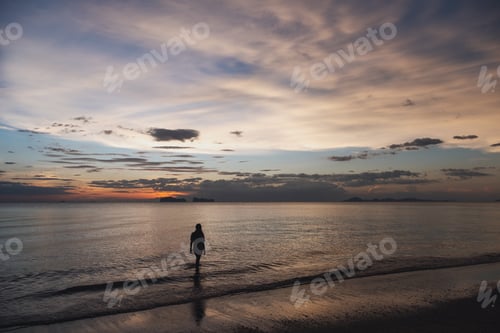 Preview: Silhouette Image Of A Woman Walking In The Sea Before Sunset