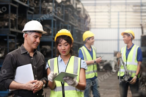 Preview: Industrial Engineer Worker Woman And Man Wearing Helmet Discussing And Working Together, Holding
