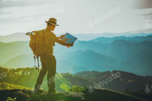 Preview: The Young Man With A Lifted Backpack Looked In Binoculars Sitting On Top Of The Mountain, Enjoying