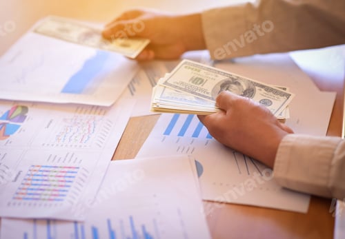 Preview: Business Finance Papers with Money on a Desk