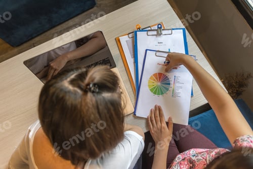 Preview: Top View Of Young Ladies Discuss About Income Reports