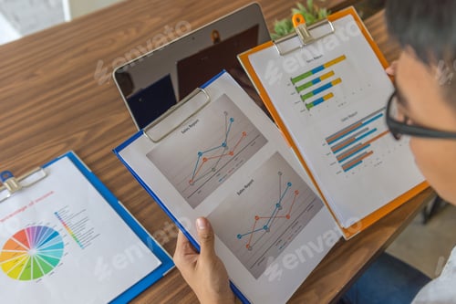 Preview: Office Employee Checking The Data On Sales Reports In Office