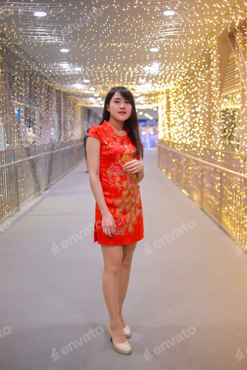 Preview: The Beautiful Lady In Chinese Dress With Light Bulb Background. Happy Chinese New Year Concept.