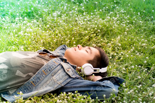 Preview: Freedom Lifestyle,Young Man Relaxing In The Park .Young Man Lying On A Grass And Listens To Music