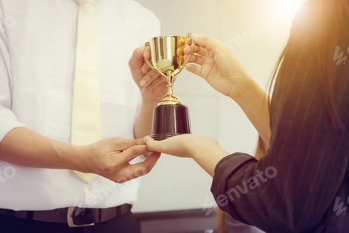 Preview: Business Man And Woman Holding Trophy Success Celebration Team Concept.