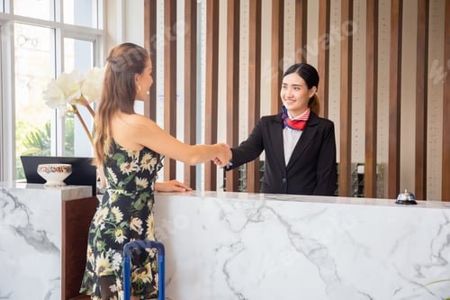Preview: Happy Receptionist And Guest Making Handshake At Hotel Reception, Receptionist Standing At Hotel