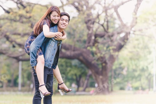 Preview: Asian Couple Lovers Under A Vast Field Of Nature In A Park.
