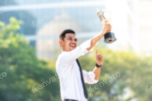 Preview: Blurred Image - Businessman Wins A Trophy. Top Employee Concept