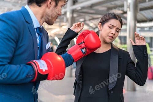 Preview: Business People Fighting With Wearing Red Glove. Man Put Punch To Woman. Concept Of Business