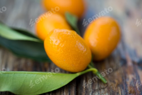 Preview: Fresh Raw Kumquat Fruits, The Chinese Mandarins, On A Wooden Board
