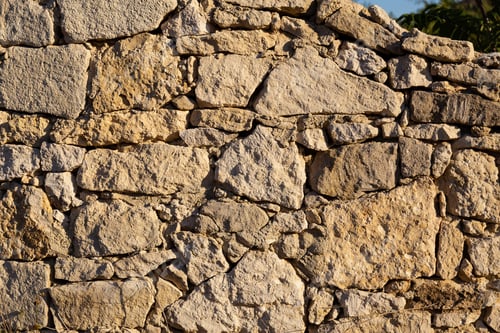 Preview: The Rough Textured Surface Of The Wild Stone Wall. Background