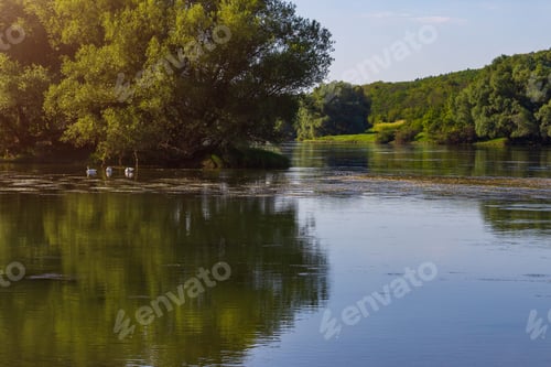 Preview: View Of The River In The Rays Of The Sunset. Toned Background Selective Focus.